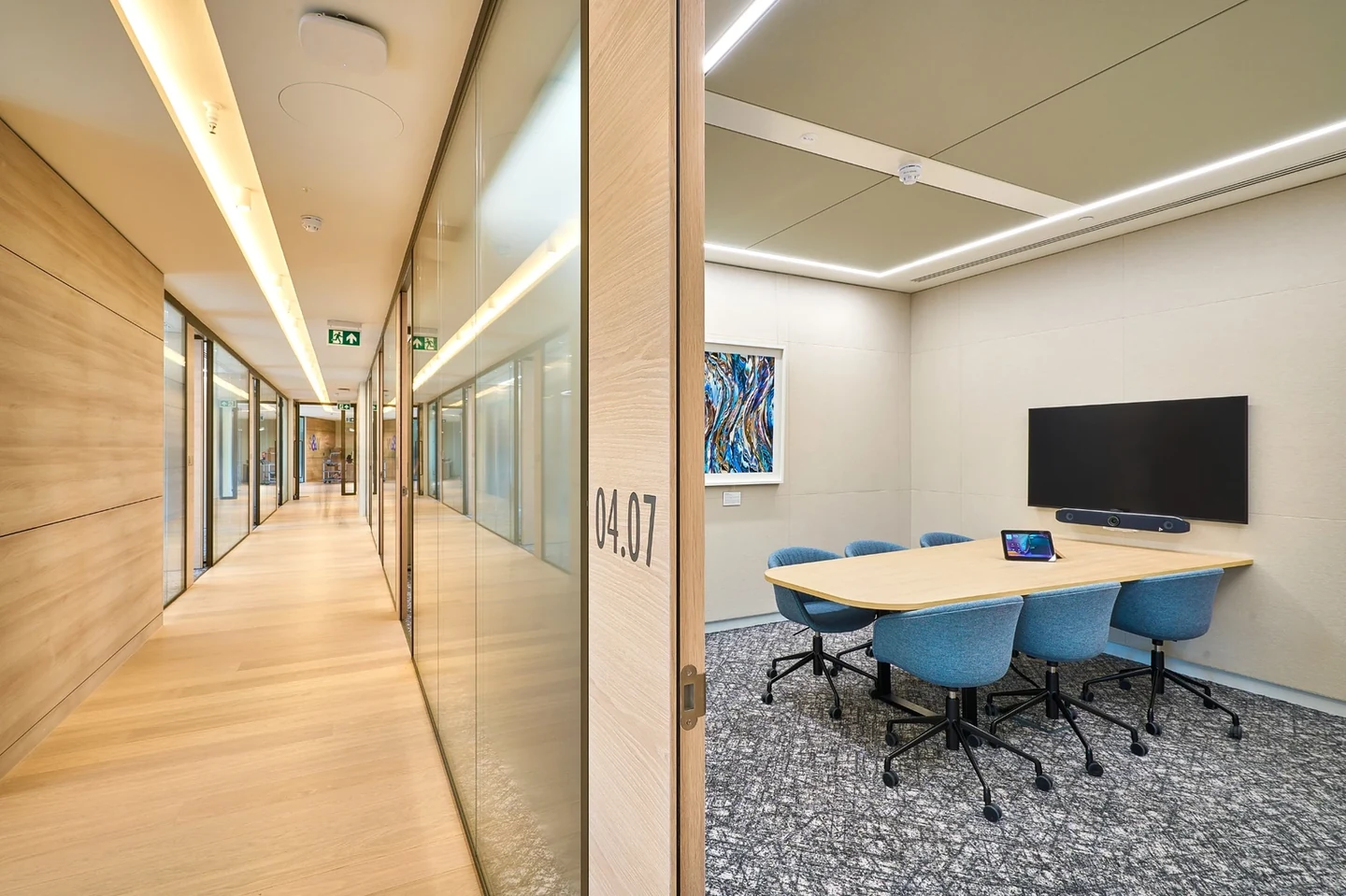 Timber-lined corridor with glazed meeting-room frontage